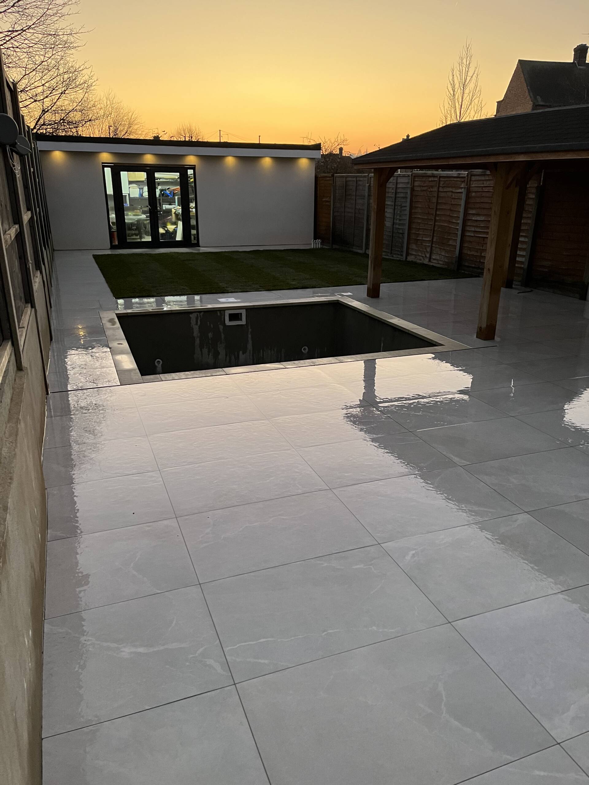 Stunning garden in the sunset with beautiful decking, lawn and concrete works